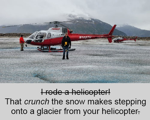 Chad standing in front of red and white helicopter