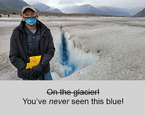 Chad standing next to a crevasse on a glacier